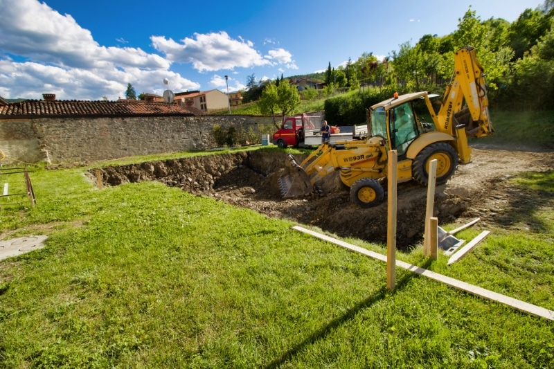 man working in a building site with big excavator