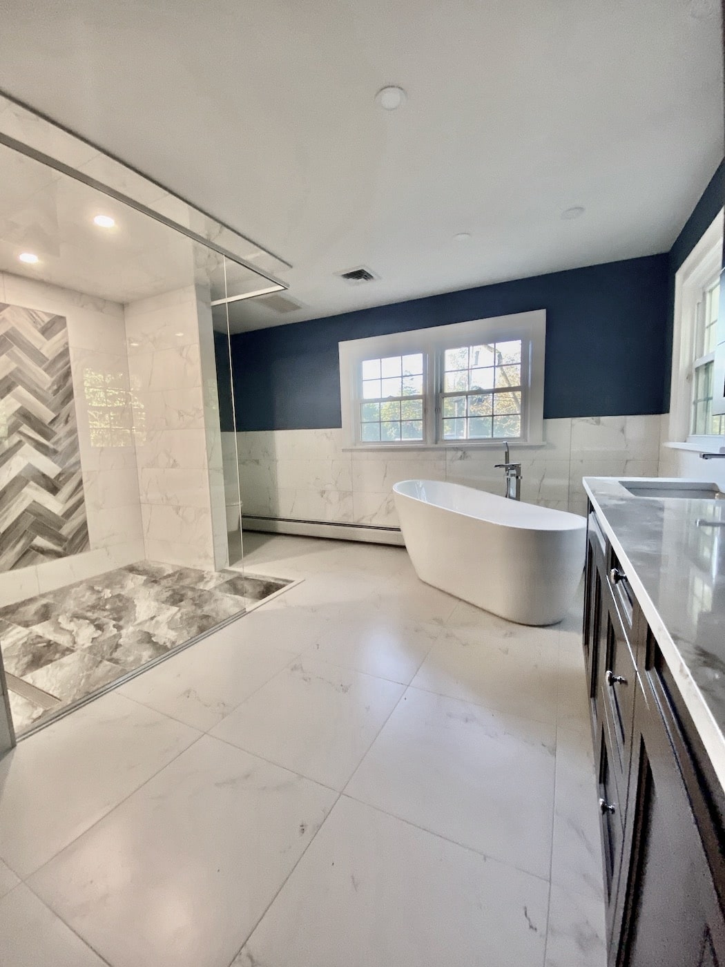 A luxurious oasis in Upper Saddle River, New Jersey. A renovated bathroom featuring a spa shower and standalone tub. Contractors - Loughlin & Son Construction.