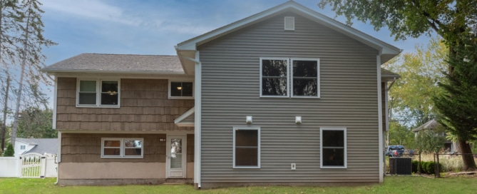 A home with Brown siding in Ramsey, NJ with a new addition by Loughlin & Son Construction