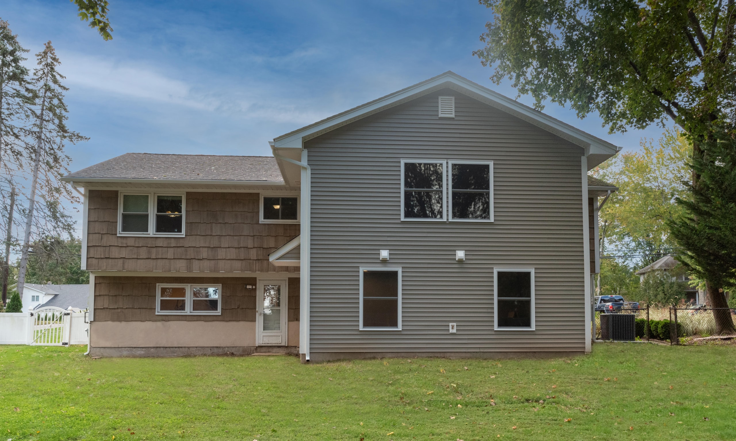 A home with Brown siding in Ramsey, NJ with a new addition by Loughlin & Son Construction